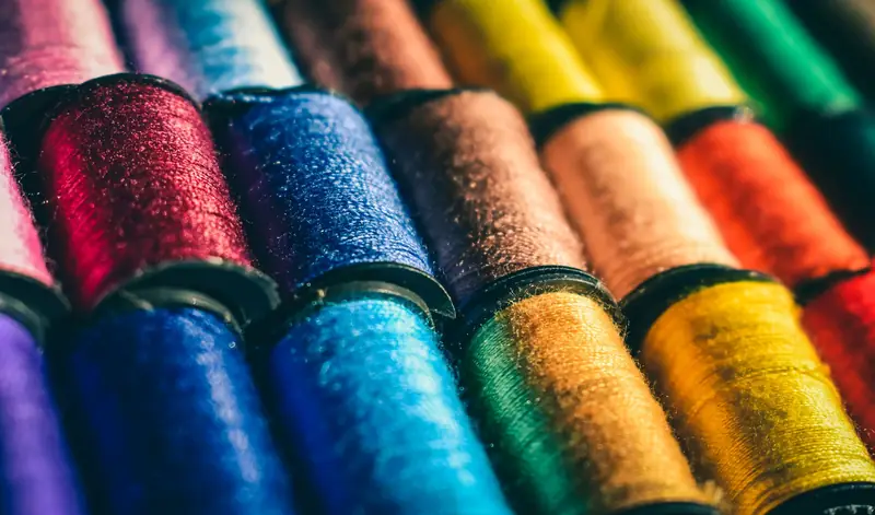 Close-up of embroidery thread spools in every colour